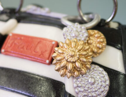 Close up of badge on handbag cake