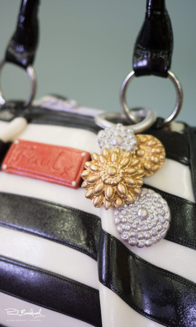 Close up of badge on handbag cake