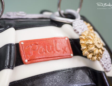 Close up of badge on handbag cake