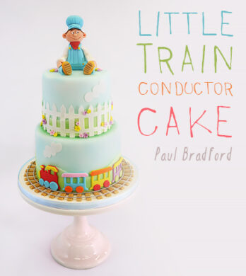 little boy model on top of two tier cake