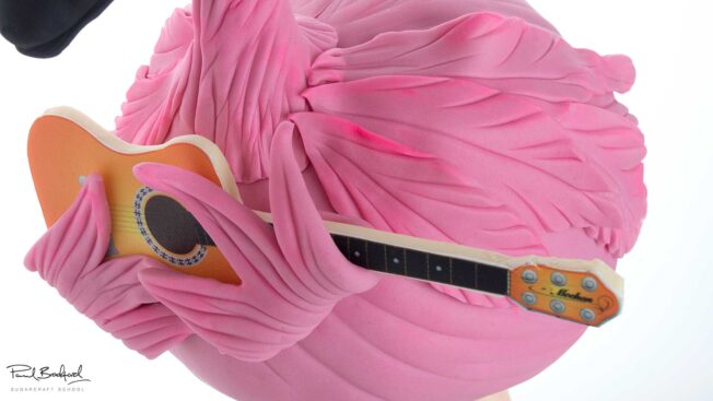 flamingo holding guitar