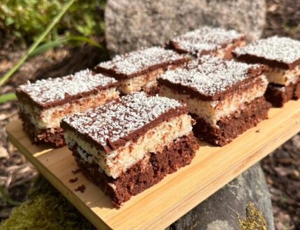 Luxury chocolate coconut brownies by Paul Bradford, cut into squares and finished with a chocolate topping and desiccated coconut.