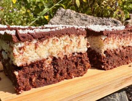 Luxury chocolate coconut brownies by Paul Bradford, cut into squares and finished with a chocolate topping and desiccated coconut.