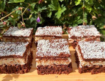 Luxury chocolate coconut brownies by Paul Bradford, cut into squares and finished with a chocolate topping and desiccated coconut.